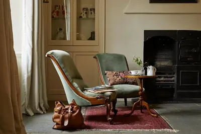 a living room with two chairs and a table at Victorian House in Grasmere
