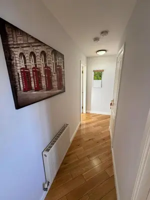 a hallway with a painting on the wall at Seaview Retreat in Troon