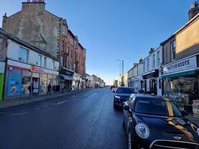 a street with cars parked on the side of the road at Seaview Retreat in Troon