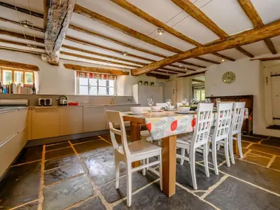 a kitchen with a table and chairs in a room at 4 Bed in Nr Keswick oc-sz231 in Braithwaite