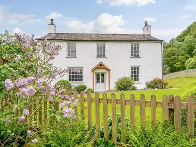 a white house with a wooden fence at 4 Bed in Nr Keswick oc-sz231 in Braithwaite