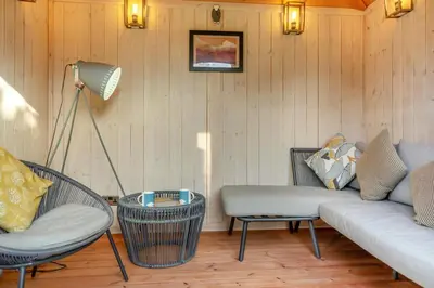 a living room with a couch and chairs and a lamp at 1 Bed in Uldale oc-g34032 in Uldale
