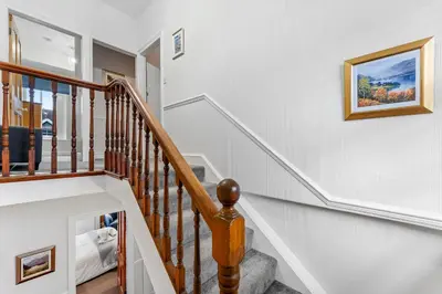 a staircase in a home with white walls at Newlands House - Quiet Keswick Retreat with Stunning Fell Views, Walk to Town in Keswick