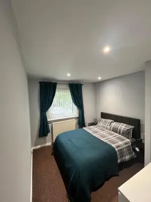 a bedroom with a bed and a window at 100 Castle in New Cumnock