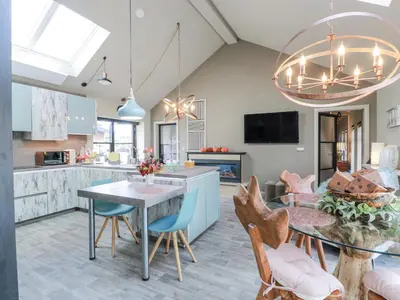 a kitchen and dining room with a table and chairs at Scotia At The Brig in Annan