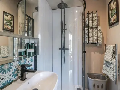 a bathroom with a shower and a sink at Cabin At The Brig in Annan
