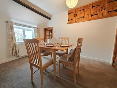 a dining room with a wooden table and chairs at 2 Bed in Wigton oc-b34112 in Caldbeck