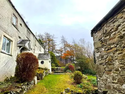 an outside view of an old stone building with a yard at 5 Bed in Wigton oc-b34111 in Caldbeck