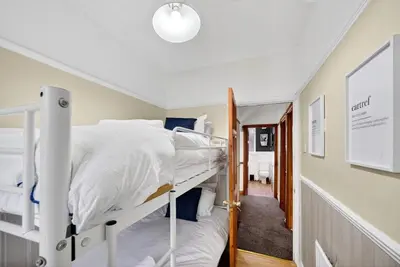 a bedroom with two bunk beds and a hallway at Spacious 5BR Home in Cardiff Bay with Office Area in Moffat
