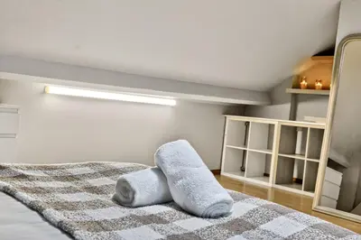 a bedroom with a bed with a towel on it at Spacious 5BR Home in Cardiff Bay with Office Area in Moffat