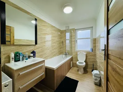 a bathroom with a toilet and a sink at 3 bedroom luxury Apartment in Prestwick