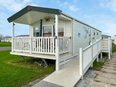 a mobile home with a porch and a white deck at H And D Greenan Village in Ayr