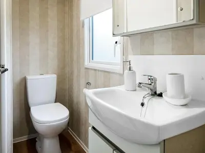 a bathroom with a white sink and a toilet at H And D Greenan Village in Ayr