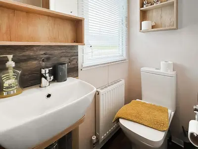 a bathroom with a white sink and a toilet at Rorys Retreat - Ukc7144 in Ayr