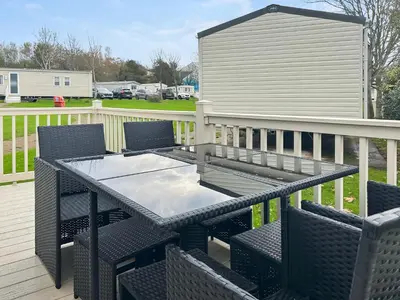 a patio table and chairs on a deck at Rorys Retreat - Ukc7144 in Ayr