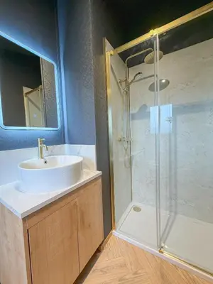 a bathroom with a sink and a shower at Blackthorn Timber Lodge in Bothel