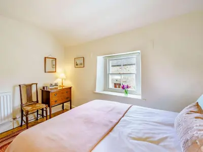 a bedroom with a bed and a window and a desk at 2 Bed in Eaglesfield 85288 in Eaglesfield