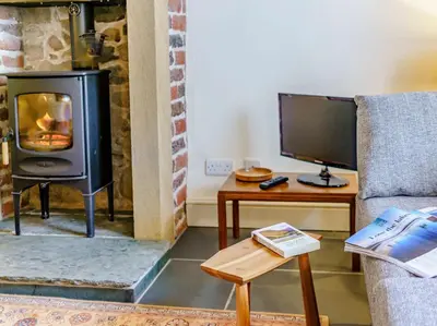 a living room with a television and a stove at 2 Bed in Eaglesfield 85288 in Eaglesfield