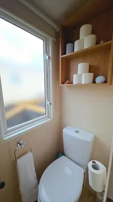 a small bathroom with a toilet and a window at Ruby Atlas Monreith in Monreith