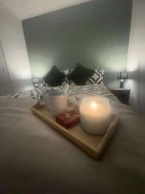 a tray with two candles on top of a bed at West Lakes 3 Bedroom - Sleeps 5 - Self Check In - Fully Furnished House in Workington