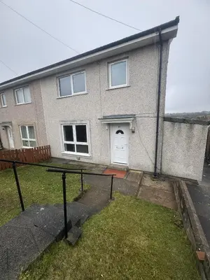 a brick house with a white door and a yard at West Lakes 3 Bedroom - Sleeps 5 - Self Check In - Fully Furnished House in Workington