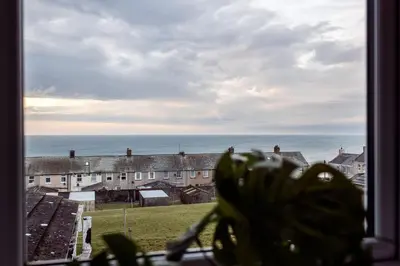 a view of the ocean from a window at Mid Street Retreat, Steps from the Beach, Whitehaven in Whitehaven