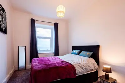 a bedroom with a bed and a window at Mid Street Retreat, Steps from the Beach, Whitehaven in Whitehaven