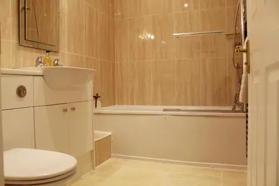 a bathroom with a toilet and a tub and a sink at Azalea in Keswick