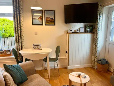 a living room with a couch and a table at Handy for Lake District, detached property in Penruddock