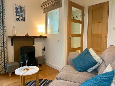 a living room with a couch and a table at Handy for Lake District, detached property in Penruddock