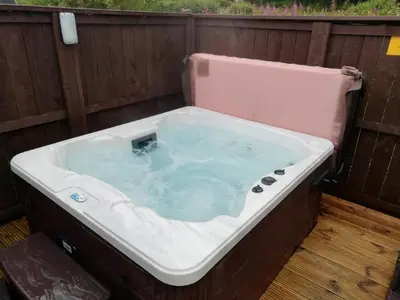 a jacuzzi tub sitting on top of a deck at Barrhill Holiday Park - Glamping in South West Scotland - Stinchar in Girvan