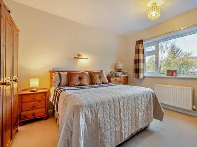 a bedroom with a large bed and a window at Blengfell by Prestige Properties SA in Gosforth