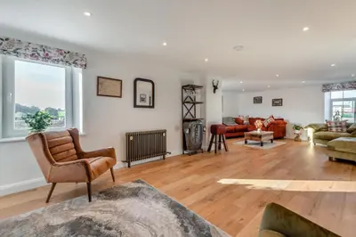 a living room filled with furniture and a large window at 3 Bed in Wigton oc-f33746 in Westward