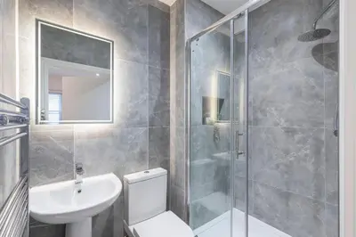 a bathroom with a toilet and a sink and a shower at Stone Street Modern 3-Bed for Groups & Families in Broughton
