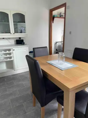 a kitchen with a wooden table with black chairs at Room with a view in Irvine
