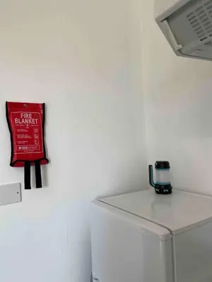 a red sign on a wall next to a refrigerator at Room with a view in Irvine