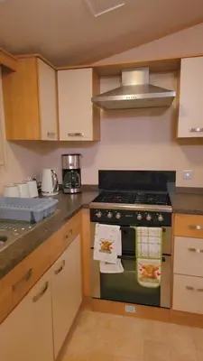 a kitchen with a stove top oven in a kitchen at 17 Ruby Atlas Monreith in Monreith