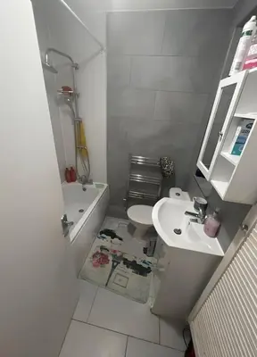 a white bathroom with a sink and a toilet at London Cozy Single Room in Moffat