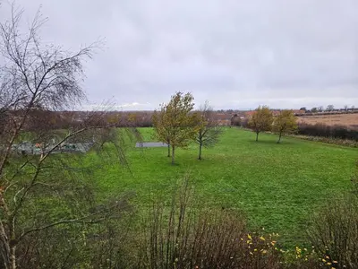 a field of green grass with trees in it at Carlisle Stunning 2 Bed Appt with Parking 5 mins J42 M6 in Carlisle