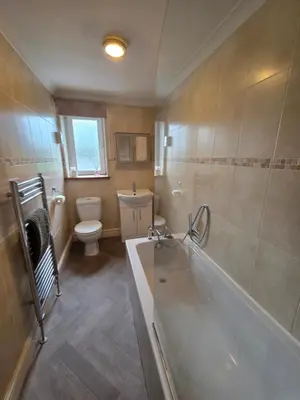 a bathroom with a tub and a toilet and a sink at Feather Bed Cottage - Dog Friendly Lakeland Retreat with Log Burner & Garden