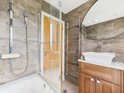 a bathroom with a tub and a sink and a shower at The Haven Holiday Home in Woodend