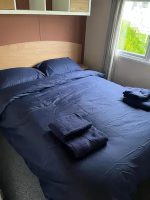 a blue bed with two pillows on top of it at MaCEIDEIRD in Mainsriddle