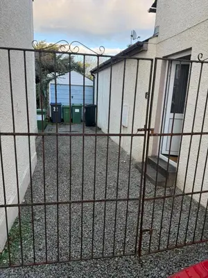 a fence with the ocean in the background at Cockermouth Cottage - Lakes - Parking in Cockermouth