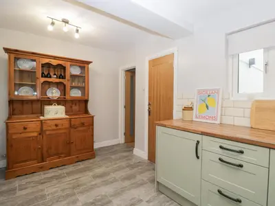 a kitchen with a wooden cabinet in a room at Mables in Wigton