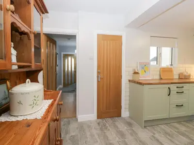 a kitchen with a wooden counter and a wooden door at Mables in Wigton