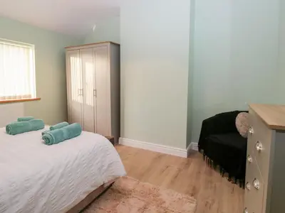 a bedroom with a bed and a dresser at Mables in Wigton