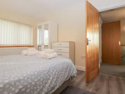 a bedroom with a bed with towels on it at Mables in Wigton