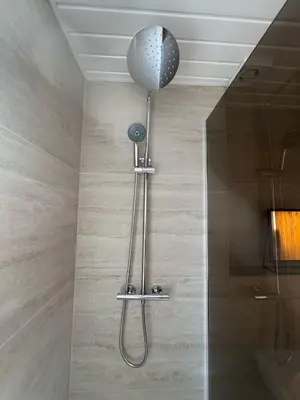 a shower in a bathroom with a shower head at Central Carlisle Modern 4BD w Wi-Fi, Washer, & SmartTVs, close to M6 in Carlisle