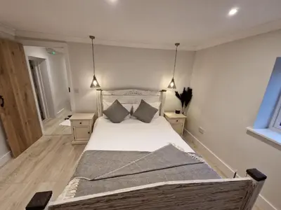 a bedroom with a large bed with two night stands at The Old school House in Moffat