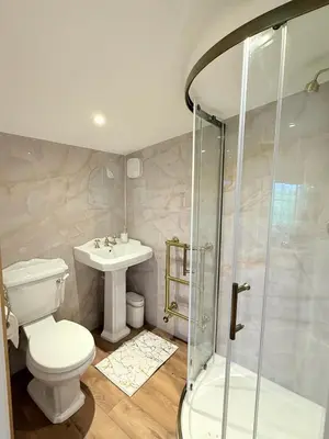 a bathroom with a toilet and a sink and a shower at Wild Meadow Cottage - Countryside Views and King Bed in Maybole